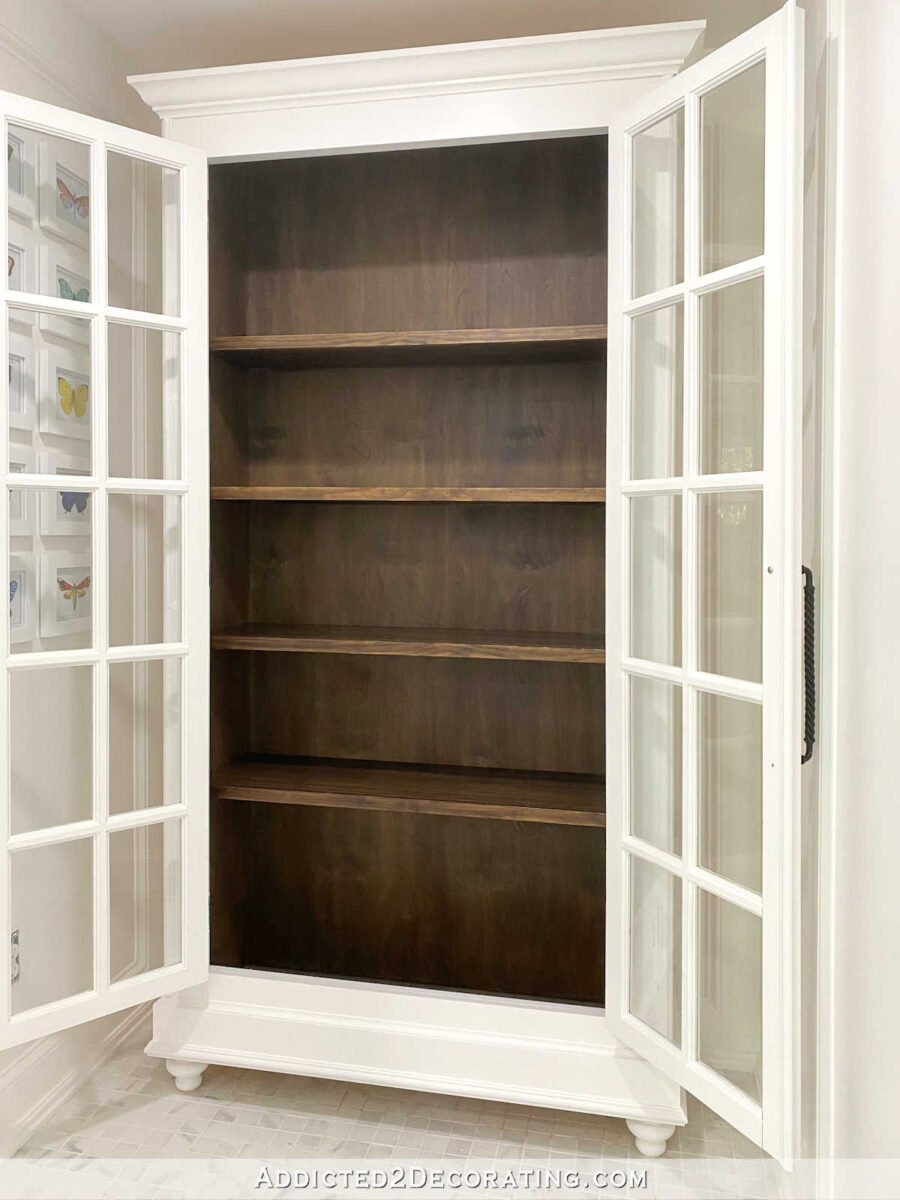 Large DIY storage cabinet with stained interior and shelves, painted exterior